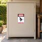 Warning Dangerous Gases Fun Sign Sticker applied to a beige private driveway workshop cabinet