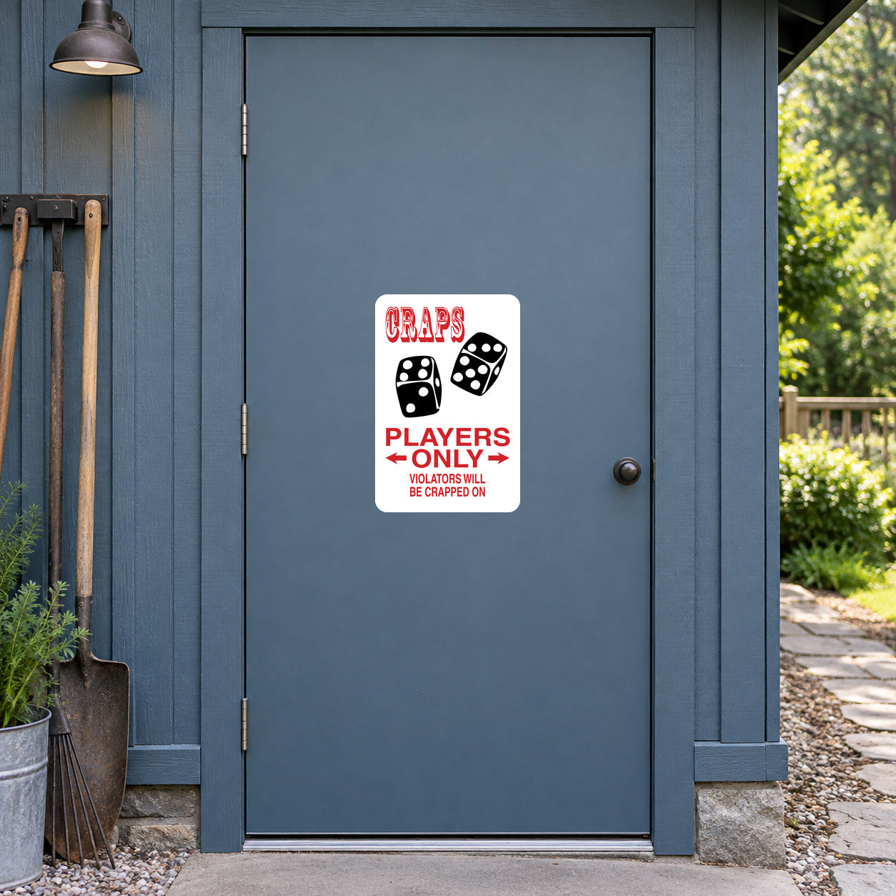 Craps Players Only Violators will be Crapped On Sticker applied to a slate blue rural workshop door