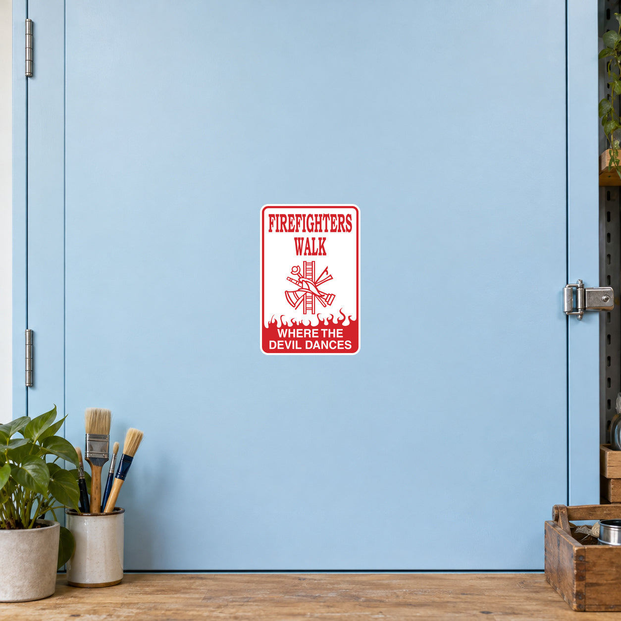 Firefighters Walk Where the Devil Dances Sticker applied to a pale blue creative workshop cabinet