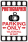 Photographer parking only sticker with camera icon and text: violators will be shot
