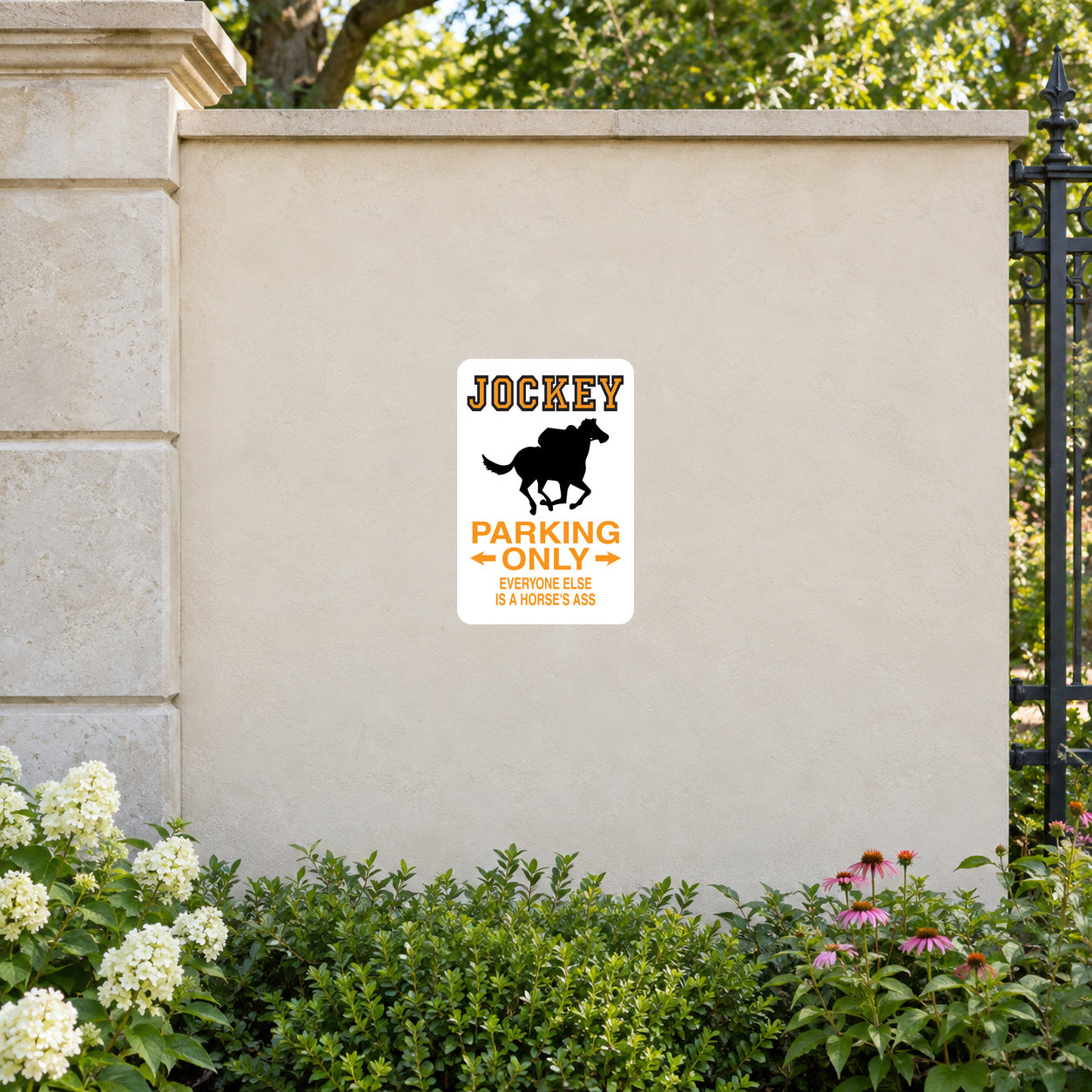 Fun Sign Sticker applied to a cream garden entrance wall beside an iron fence