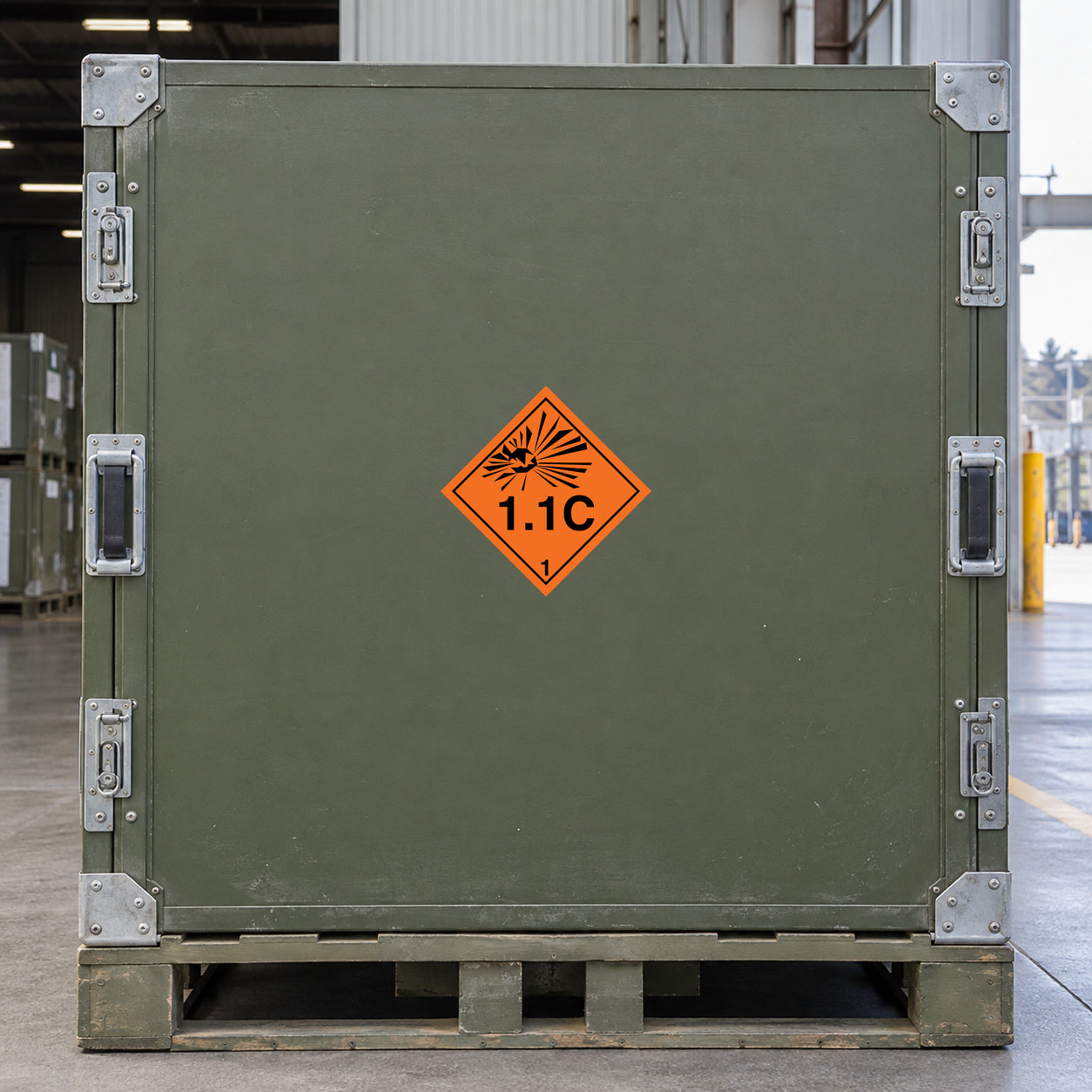 Hazardous Safety Sign Sticker applied in a specialized freight warehouse, flat olive green rigid shipping case side, metal corner reinforcements and pallet at outside edges