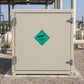 Green diamond hazardous gas safety sticker on beige metal door: non flammable gas, class 2