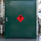 Hazardous Safety Sign Sticker applied in a marine maintenance solvent store, smooth deep green SINGLE-door steel cupboard, marine workshop pipes only at side edges