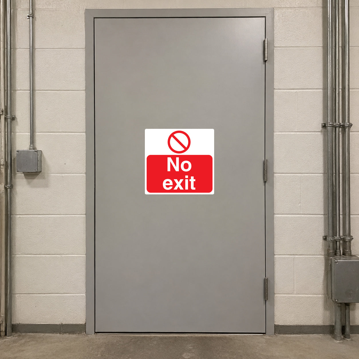 NO Safety Sign Sticker applied in a locked maintenance cupboard in a school service corridor, smooth light grey solid door, no exit hardware, electrical conduit at outside edges
