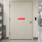 NO Safety Sign Sticker applied in pharmaceutical storage corridor entrance, solid cream composite door, card reader at far right and tiled corridor edge