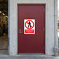 NO Safety Sign Sticker applied in railway maintenance stores entrance, solid maroon single access door, concrete frame and workshop at far left