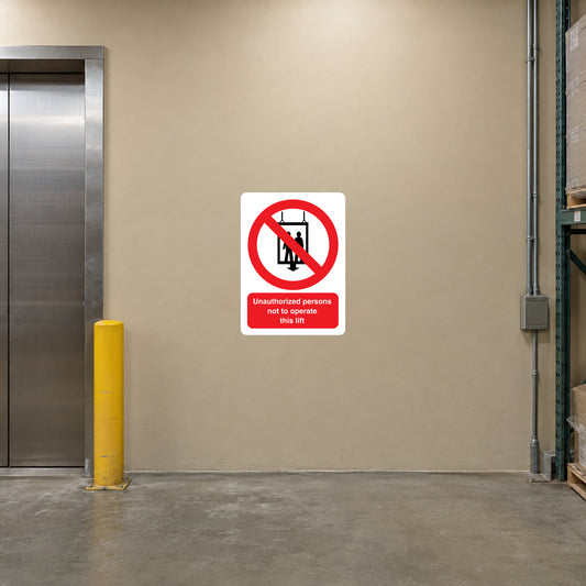 NO Safety Sign Sticker applied in warehouse freight lift landing, smooth solid sand-colored SINGLE stationary wall beside lift, closed lift gate at far left edge