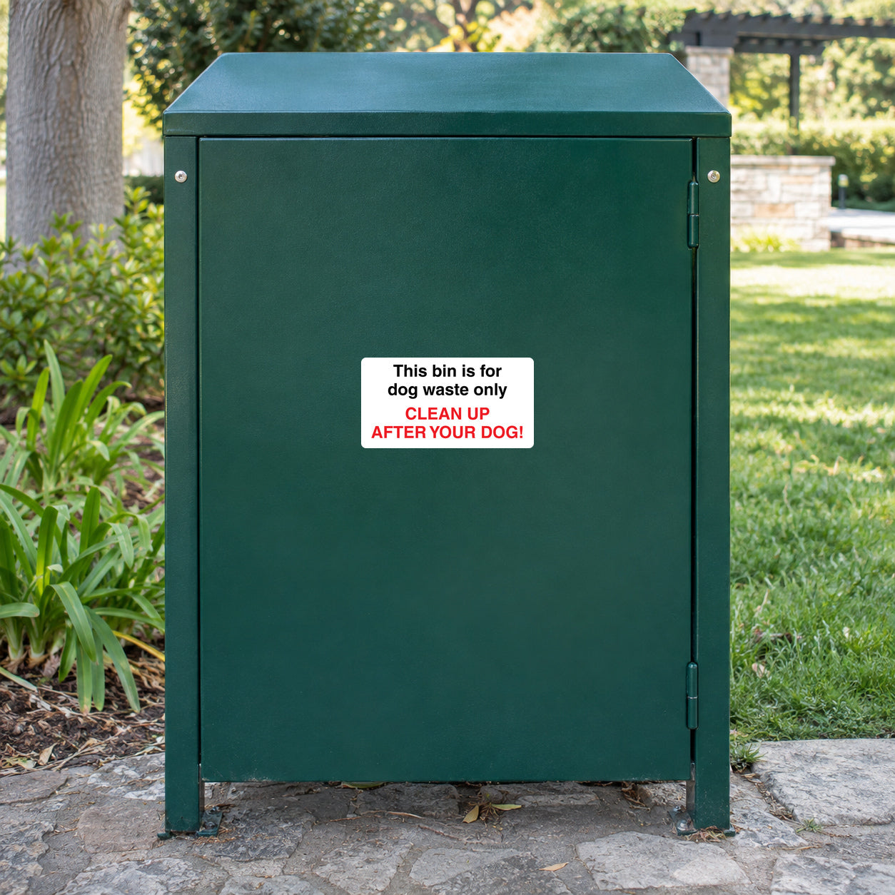 No Dogs sign sticker on green trash bin: red 'CLEAN UP AFTER YOUR DOG!'