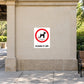 NO Dogs Sign Sticker applied in a smooth pale sandstone park pavilion exterior wall, walking path at bottom and bench at extreme right