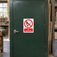 No naked lights sign sticker with red circle and slash over a flame icon