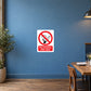 NO Smoking Sign Sticker applied in muted blue restaurant dining area solid wall, table corner at far side