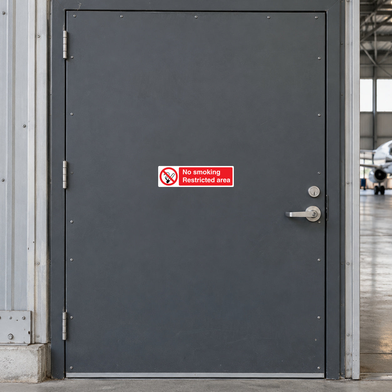No smoking sticker, red prohibition symbol and 'Restricted area' text