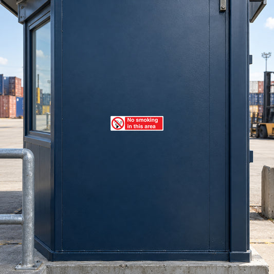 NO Smoking Sign Sticker applied in dark blue smooth security cabin wall in a cargo yard