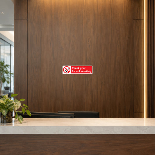 NO Smoking Sign Sticker applied in walnut veneer wall in a professional office reception, counter at outer edge