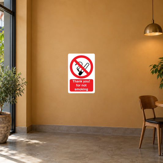 NO Smoking Sign Sticker applied in smooth ochre cafe foyer wall with an unoccupied chair far right