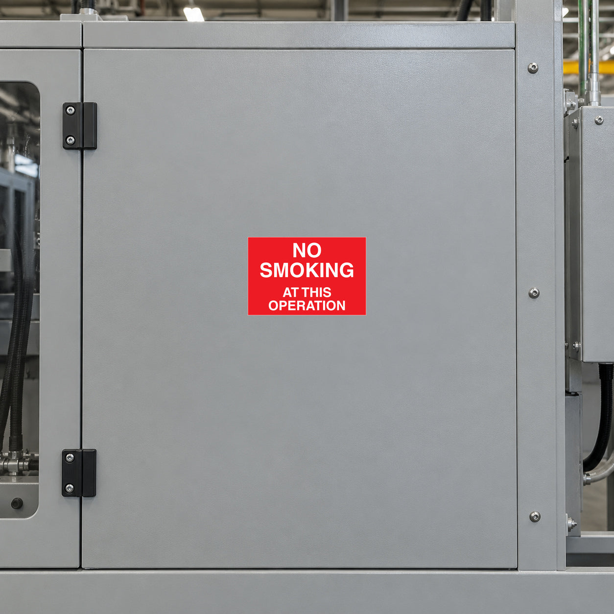 No smoking sign sticker with red background and white text on gray metal door