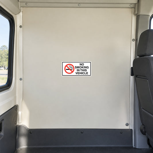 NO Smoking Sign Sticker applied in flat cream rigid interior panel behind the front passenger seat of an unoccupied commercial shuttle van, seat and window only at edges