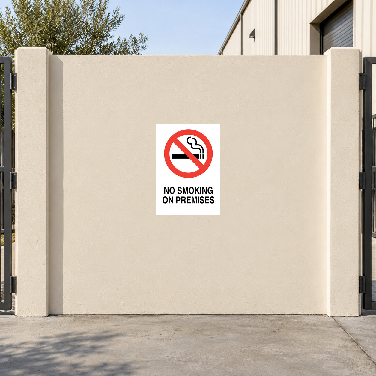 NO Smoking Sign Sticker applied in flat cream courtyard gate outside a warehouse
