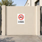 NO Smoking Sign Sticker applied in flat cream courtyard gate outside a warehouse