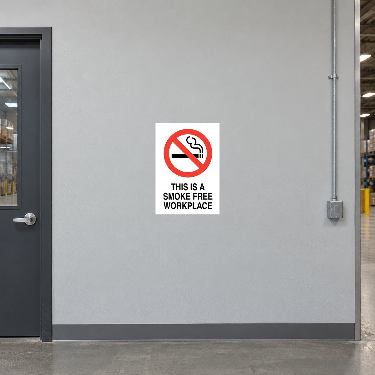 NO Smoking Sign Sticker applied in light grey smooth office hallway wall in a warehouse