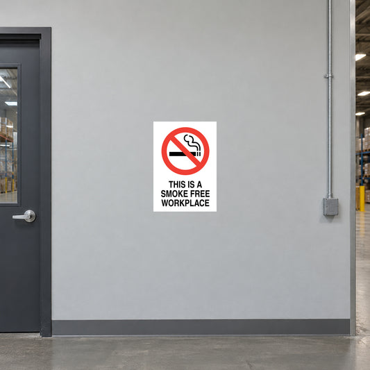 NO Smoking Sign Sticker applied in light grey smooth office hallway wall in a warehouse