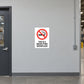 NO Smoking Sign Sticker applied in light grey smooth office hallway wall in a warehouse