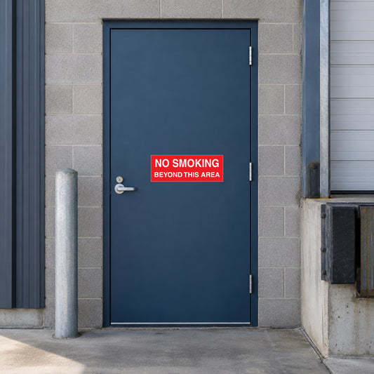 NO Smoking Sign Sticker applied in single dark blue staff door beside a loading dock
