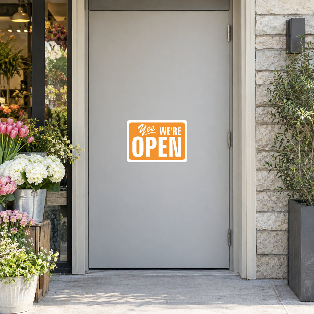 Open sign sticker showing "Yes We're OPEN" text on a white badge