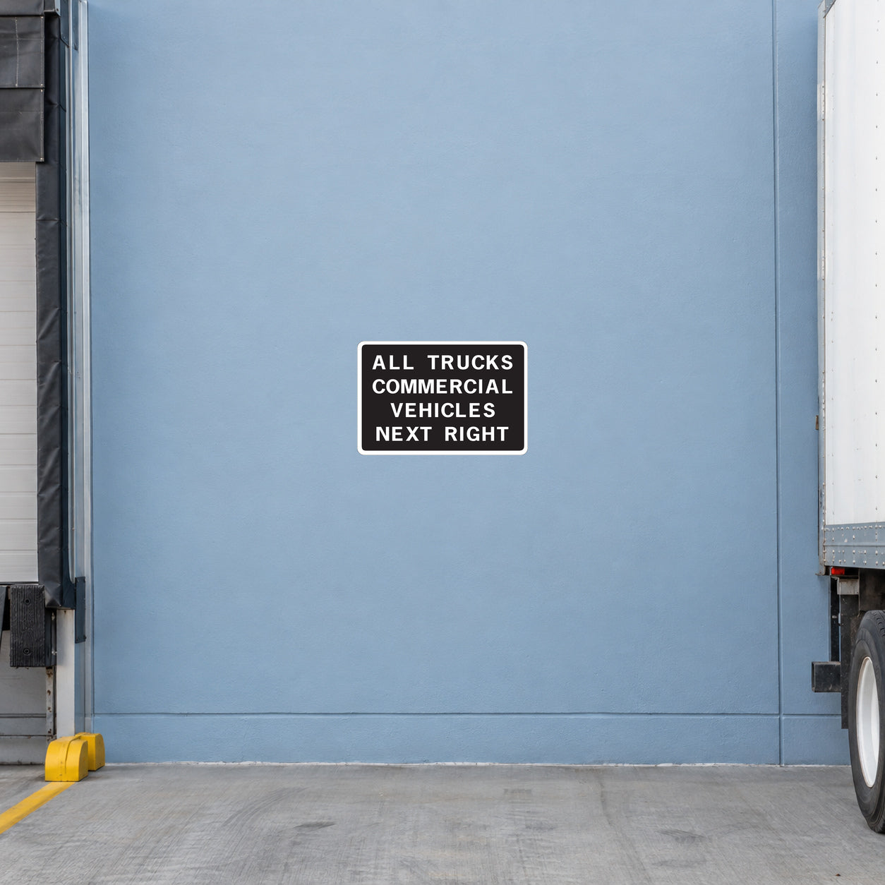 Road sign sticker with black border, reads: ALL TRUCKS COMMERCIAL VEHICLES NEXT RIGHT