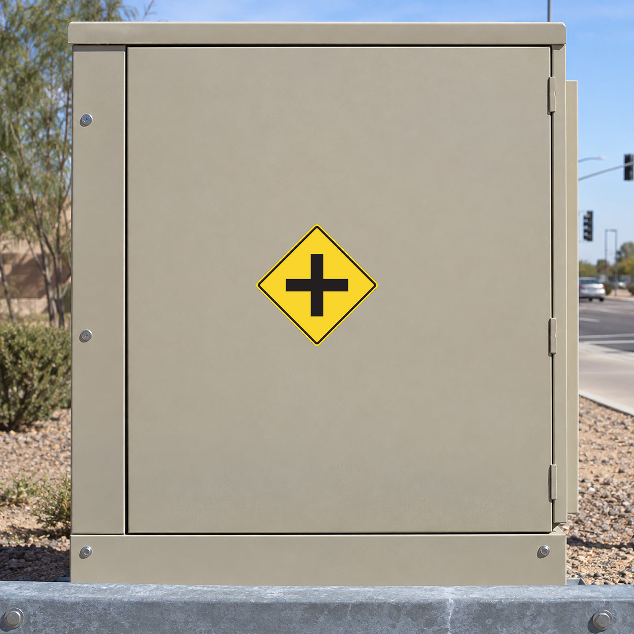 Road sign sticker with yellow diamond and black plus symbol