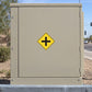 Road sign sticker with yellow diamond and black plus symbol