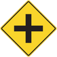 Yellow road sign sticker with black plus-shaped cross inside a diamond border