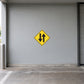 Yellow road sign sticker with black double-arrow down and up in a diamond