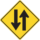 Road sign sticker: yellow diamond warning with up and down arrows