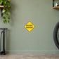 Road sign sticker with yellow diamond reading BIKEWAY NARROWS