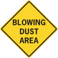 Road sign sticker: yellow diamond with black border, 'BLOWING DUST AREA' text.