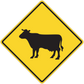 Road sign sticker with yellow diamond and black cow silhouette