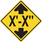 Road sign sticker: yellow diamond with black top and bottom arrows and X-X text