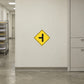 Road sign sticker with yellow diamond and black left arrow symbol