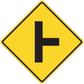 Yellow road sign sticker with black left-turn arrow inside a diamond border