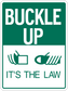 Road sign sticker with green “BUCKLE UP” warning text, “IT’S THE LAW,” and white icons