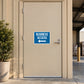 Road sign sticker: blue 'BUSINESS ACCESS' with left arrow