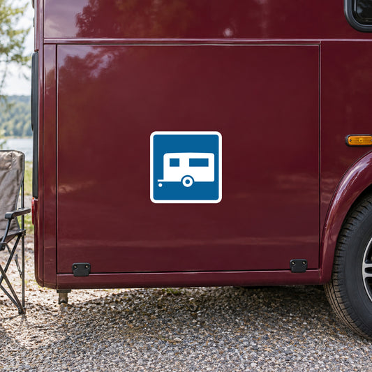 Road sign style sticker with a blue camper icon on a white border
