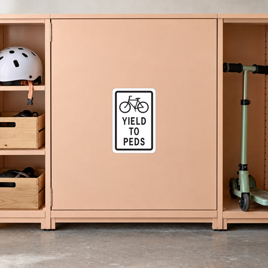 Road sign sticker with bicycle icon and "YIELD TO PEDS" text
