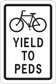 Road sign sticker with cyclist icon and text “YIELD TO PEDS”