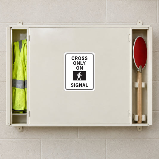 Road sign sticker with white border: "CROSS ONLY ON SIGNAL" pedestrian symbol