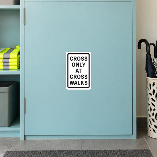 Road sign sticker with "CROSS ONLY AT CROSS WALKS" text
