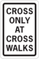 Road sign sticker with text: "CROSS ONLY AT CROSS WALKS"