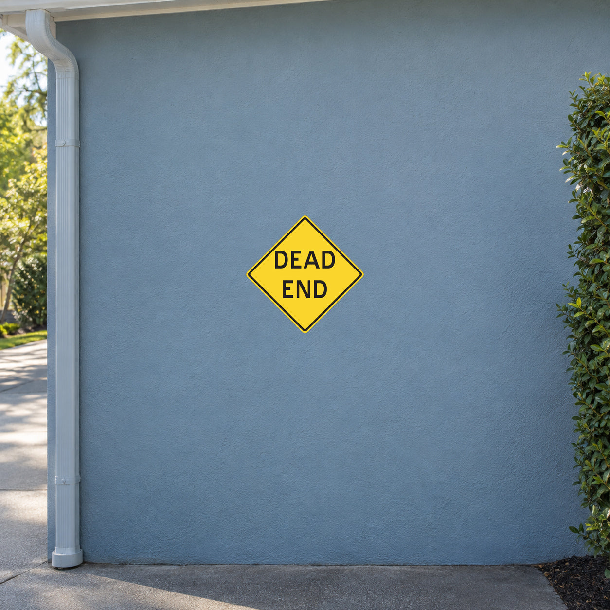 Yellow road sign sticker with black border, diamond shape, text "DEAD END"